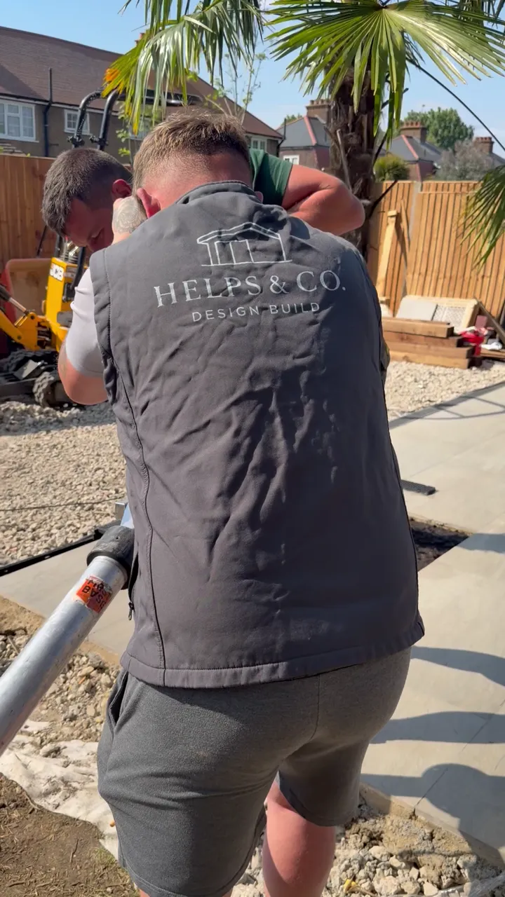 Installation equipment positioned over a marked ground screw location in a garden.